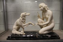 A good Art Deco alabaster and marble group modelled as a seated female nude with a Borzoi dog