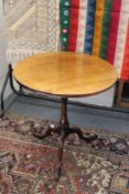 A mahogany tripod table with bird cage action.