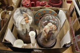 A pair of figures under glass domes and other items.