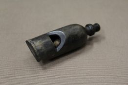 A carved rhino horn whistle.