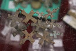 A quantity of small early bronze crucifixes.