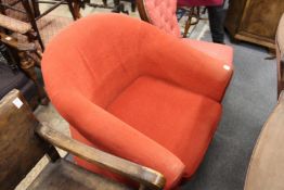 A modern red upholstered tub armchair.