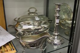 A plated tureen and cover, sauce boat and candlestick.
