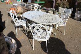 An aluminium patio table and four armchairs.