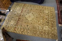 A Persian rug, beige ground with floral decoration.