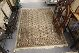 A modern pale green ground Bokhara rug.