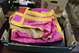 A silk embroidered tunic and a box.