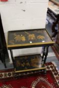 A chinoiserie decorated two tier ebonised table.