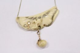 An unusual Chinese carved necklace and chain, possibly gold and horn.