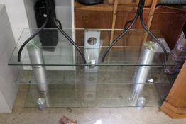 A modern glass three tier TV stand.