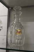 A good cut glass decanter with gilded and enamelled armorial crest.
