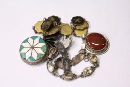 Two silver pendants and three bracelets.