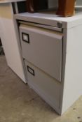 A metal two drawer filing cabinet.