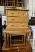 A small pine three drawer chest and a nest of pine tables.