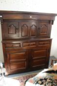 An 18th century oak court cupboard carved with the initials 'R F' and dated 1747.