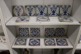 A good collection of sixteen Delft blue and white tiles, probably 18th / 19th century, mostly