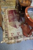 An old Persian rug, worn and cut.