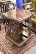 An inlaid walnut revolving bookcase.