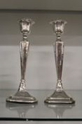 A pair of silver candlesticks.