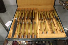 A cased set of rhino horn handled knives.