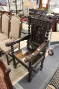 A Jacobean revival carved oak armchair.