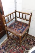 A beech framed bobbin turned corner armchair.