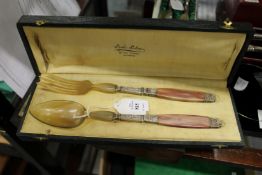 A good cased pair of horn handled salad servers.