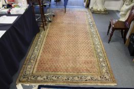 A Persian carpet, beige ground with stylized tree decoration (worn).