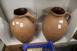 A pair of large terracotta jugs.