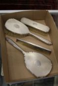 A silver four piece dressing table set.