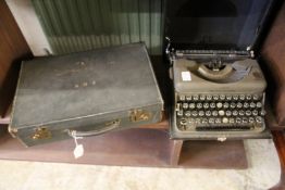 A leather writing case and an old typewriter.