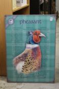 A modern metal sign depicting a pheasant.