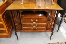 A mahogany music cabinet.