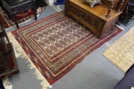 A Persian Bokhara rug.