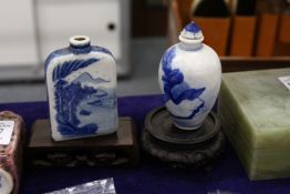 Two Chinese blue and white snuff bottles with associated stands.