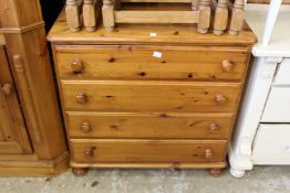 A pine chest of drawers.