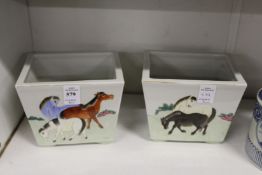 A pair of Chinese rectangular jardinieres painted with horses in landscapes.