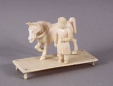 A SMALL 19TH CENTURY INDIAN SECTIONAL CARVED IVORY HORSE AND GROOM.