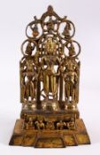 A CHINESE BRONZE THREE BUDDHA STATUE, with three buddha / deity stood upon a pedestan with animals
