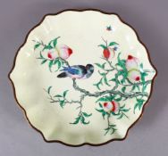A CHINESE ENAMEL PEACH BLOOM DISH, the dish with a pale yellow ground depicting a bird seated in the