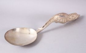 A LARGER BURMESE WHITE METAL MOULDED SERVING SPOON, the spoon with an embossed decorated floral
