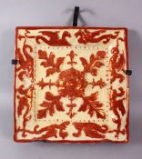 A 19TH CENTURY HISPANO MORESQUE POTTERY TILE SECTION, with a copper lustre depicting winged mythical