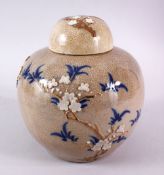 A 19TH CENTURY CHINESE CRACKLEGLAZE GINGER JAR AND COVER, decorated with flowers and blue leaves,