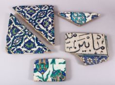 A GROUP OF FIVE 16TH/17TH CENTURY IZNIK AND DAMASCUS TILE FRAGMENTS.