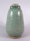 AN UNUSUAL THAI CELADON SAWAHKHALOK POTTERY VASE, with twin handles and a moulded / carved body of