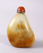 A CHINESE CARVED JADE PEBBLE SNUFF BOTTLE, with trace gilt decoration of landscapes, 8cm
