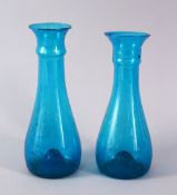 TWO 18TH CENTURY PERSIAN BLOWN GLASS TURQUOISE BOTTLE VASES, 19cm and 19.5cm.