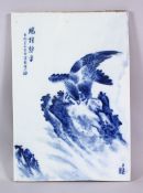 A CHINESE BLUE & WHITE PORCELAIN HAWK TILE / PANEL, depicting a hawk landed upon rocky outcrops