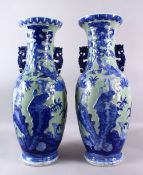 A LARGE PAIR OF 19TH / 20TH CHINESE CENTURY CELADON BLUE & WHITE PORCELAIN VASES, each decorated