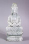 A CHINESE CARVED JADEITE FIGURE OF BUDDHA / DEITY, in a seated pose upon lotus, holding a vessel,